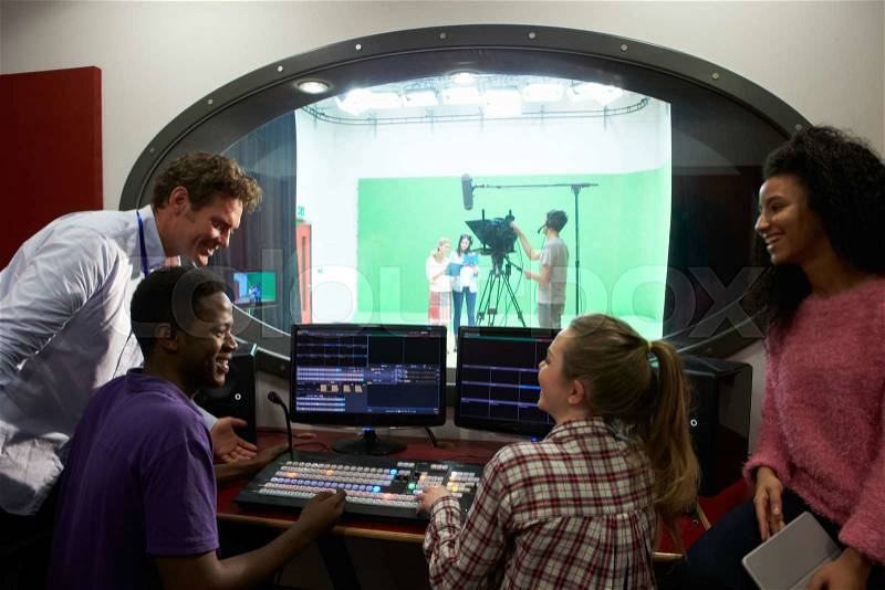 Students On Media Studies Course In TV Editing Suite, stock photo