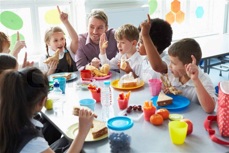 Group Of Children Eating Lunch In School Cafeteria, stock photo