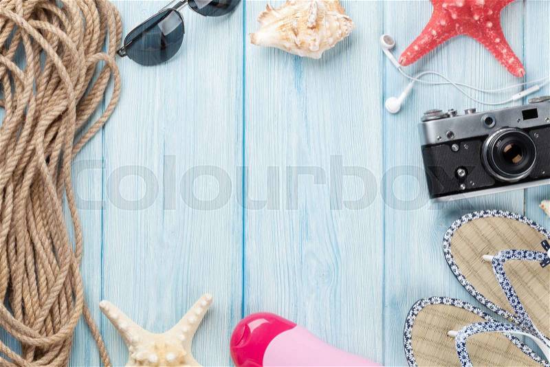 Travel and vacation items on wooden table. Top view with copy space, stock photo