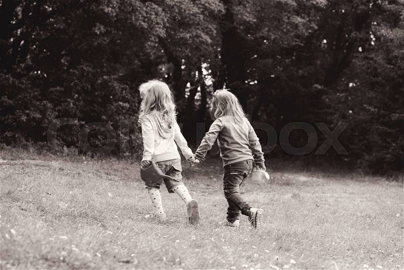 Two friends girls walking hand in hand, stock photo