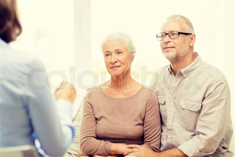 Family, relations, age and people concept - happy senior couple and psychologist or social worker at home, stock photo