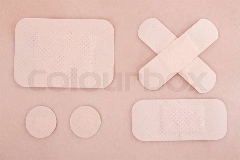 Close up of different medical adhesive plasters on skin background, stock photo
