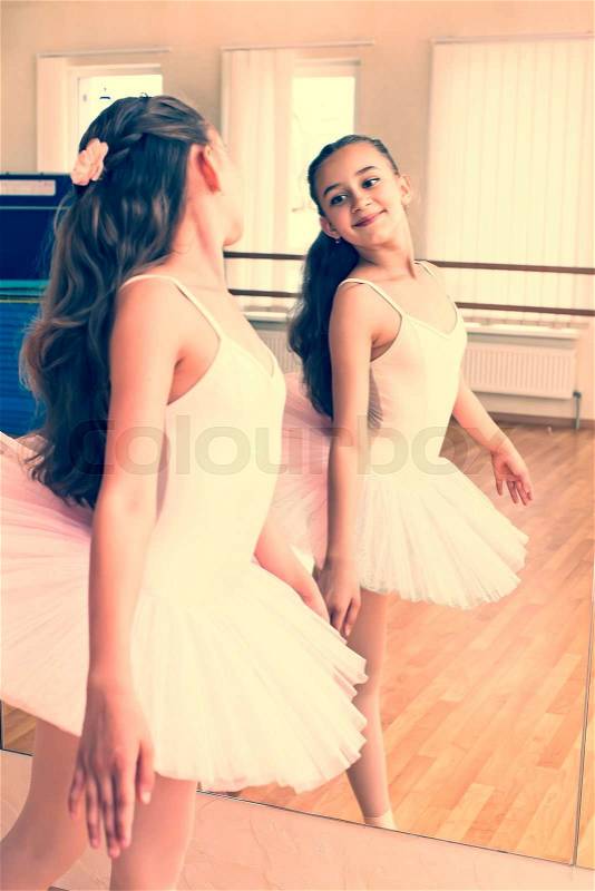 Little girl dressed as a ballerina in ballet, stock photo