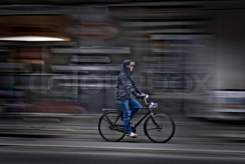 Motion blur of man on bike side viewed in Copenhagen, Denmark, stock photo