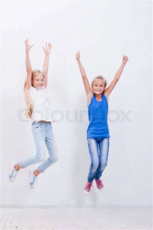 Group of happy young teens jumping over a white background, stock photo