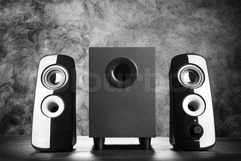 Modern black sound speakers on dark background, stock photo