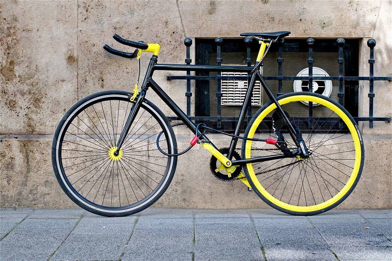 Cool black and yellow bike locked, stock photo