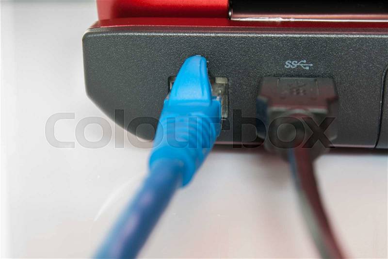Connected patch cable to laptop, plug with internet cable and laptop, stock photo