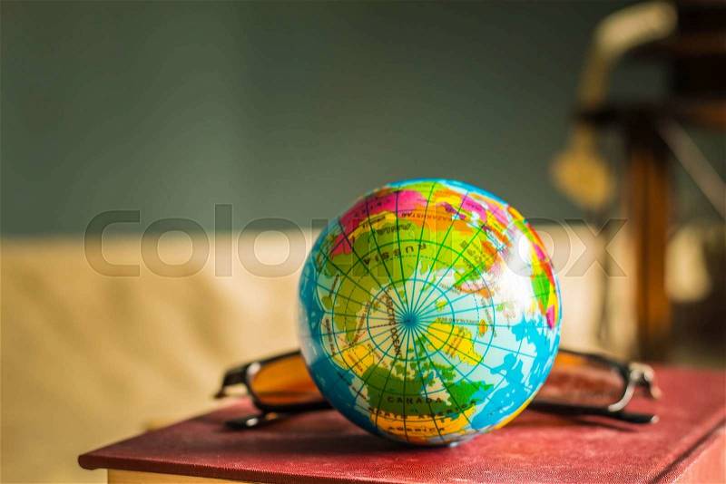 Globe and old books on the desk, stock photo