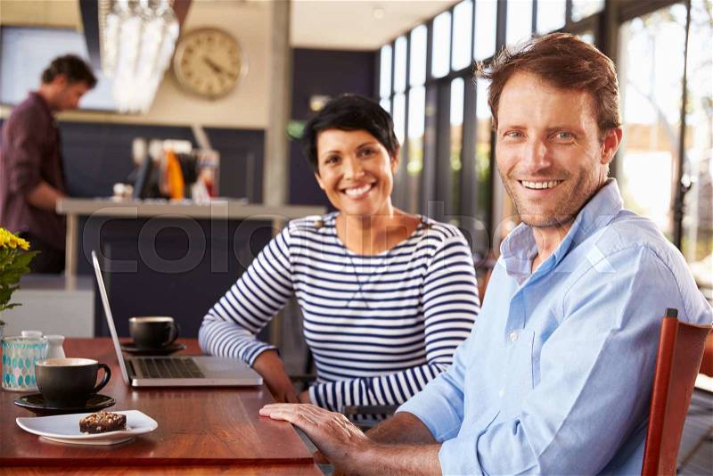 Man and woman meeting over coffee in a restaurant, stock photo