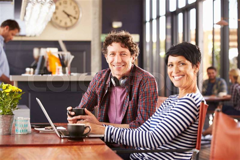 Man and woman meeting at a coffee shop, stock photo