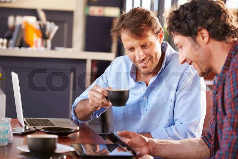 Two men meeting at a coffee shop, stock photo