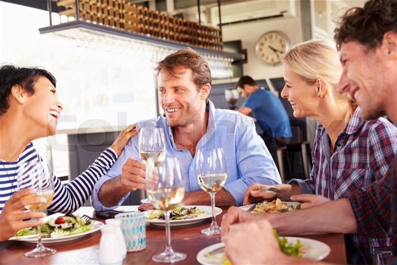 A group of friends having lunch in a restaurant, stock photo