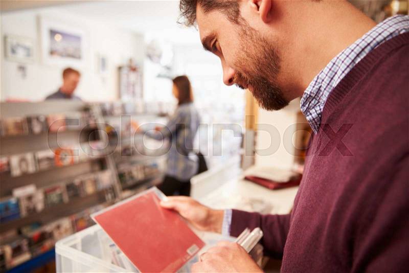 Man sorting through records at a record shop, stock photo