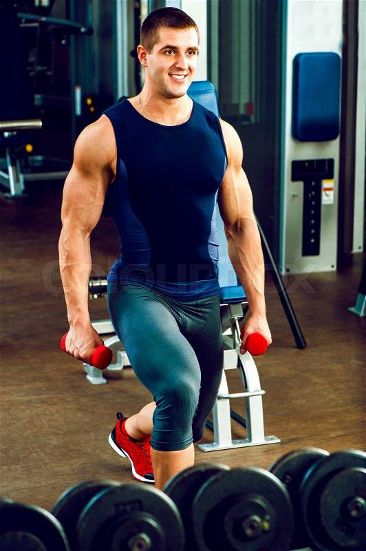 Muscular personal trainer with barbell in sports wear poses in gym.Fashion look.Healthy life.Wellness.Lifestyle.Athletic body.Exercises.Healthcare, stock photo