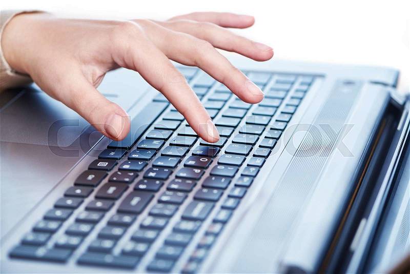 Female hand on laptop keyboard closeup, stock photo