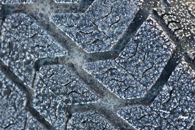 Winter tyre close-up with ice and snow, it is time to buy a winter rubber, stock photo