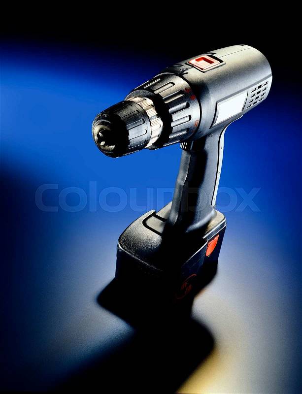 Drill with strong light effect on blue still life, stock photo