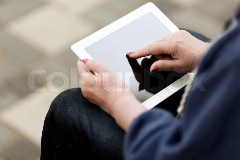 Real woman with tablet pc on the street, stock photo