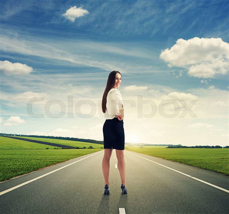 Businesswoman turning back and smiling on the road at outdoors, stock photo