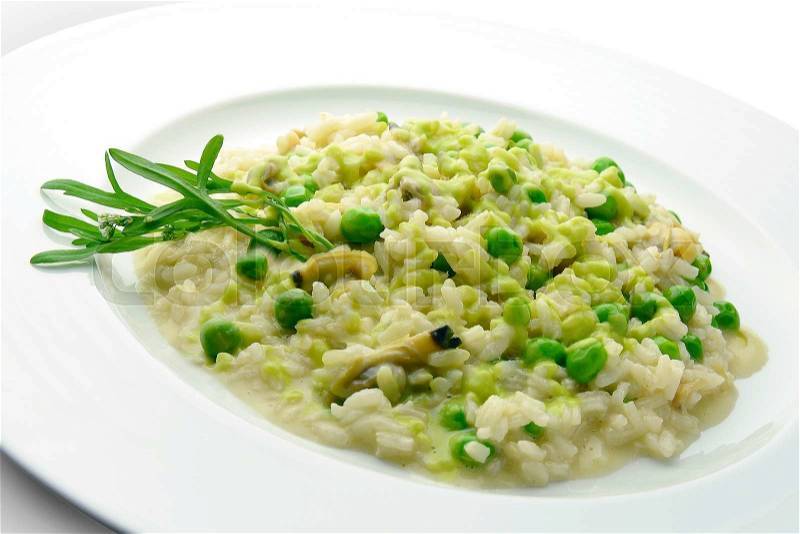Plate of Risotto with Clams and Peas in white plate, stock photo