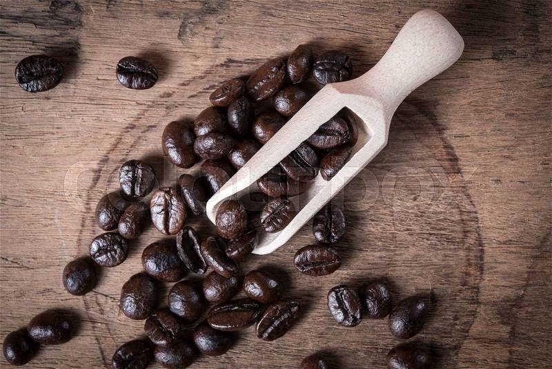 Coffee beans in wooden scoop, stock photo
