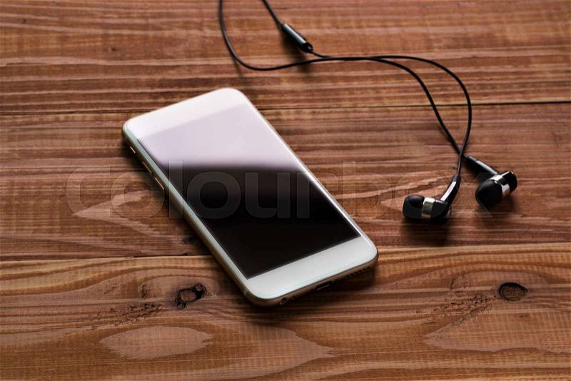 Listen the music, smart phone on the table with earphones, stock photo