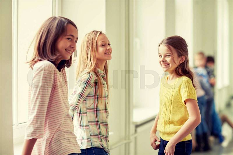 Education, elementary school, children, break and people concept - group of smiling school kids in corridor, stock photo