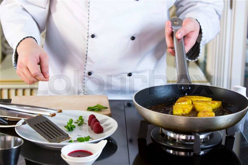 Japanese chef preparing a meal in a restaurant, stock photo