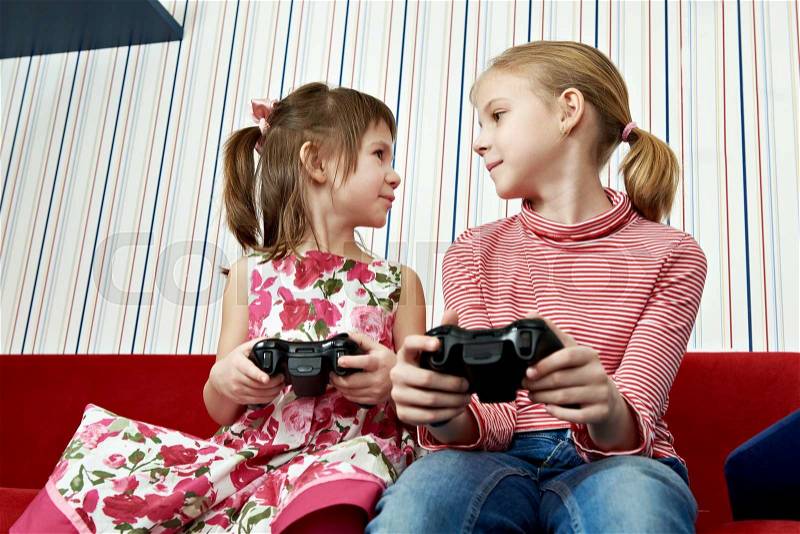 Children playing on a games console, stock photo