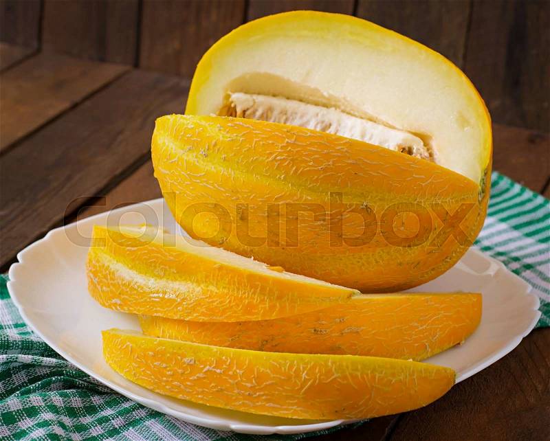 Melon cut into pieces on a plate, stock photo