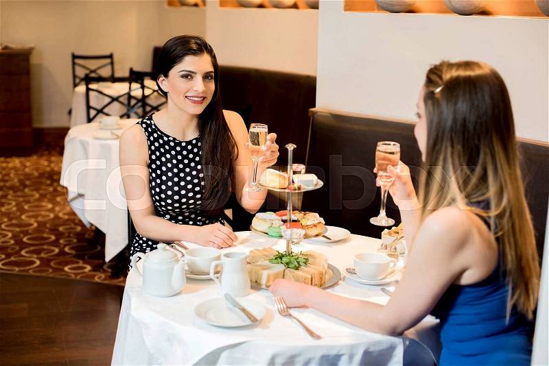 Two women conversing and enjoying dine, stock photo