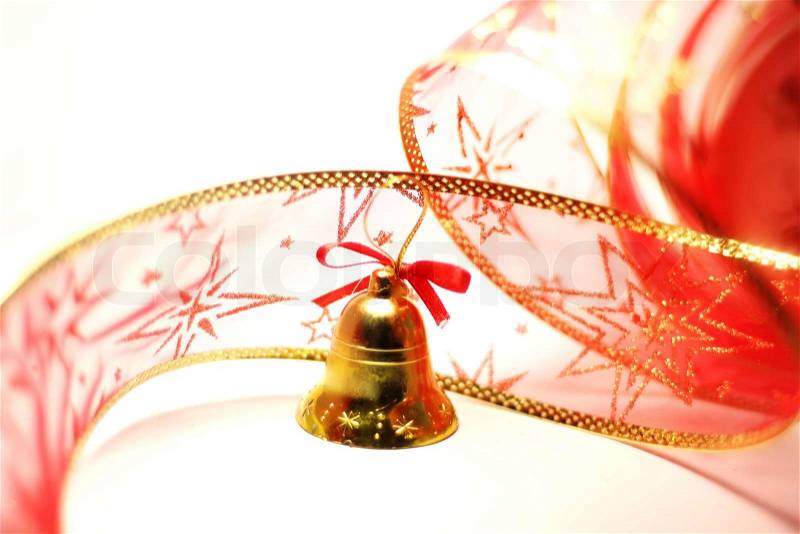 Christmas bell toy with red ribbon on white, stock photo