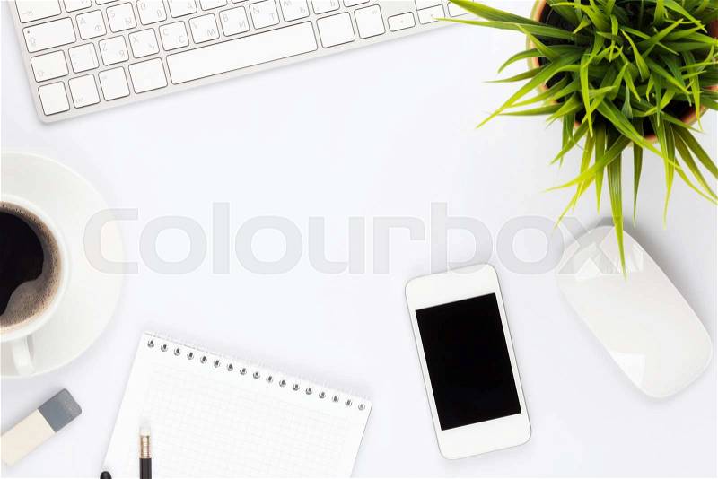 Office desk table with computer, supplies, flower and coffee cup. Top view with copy space, stock photo