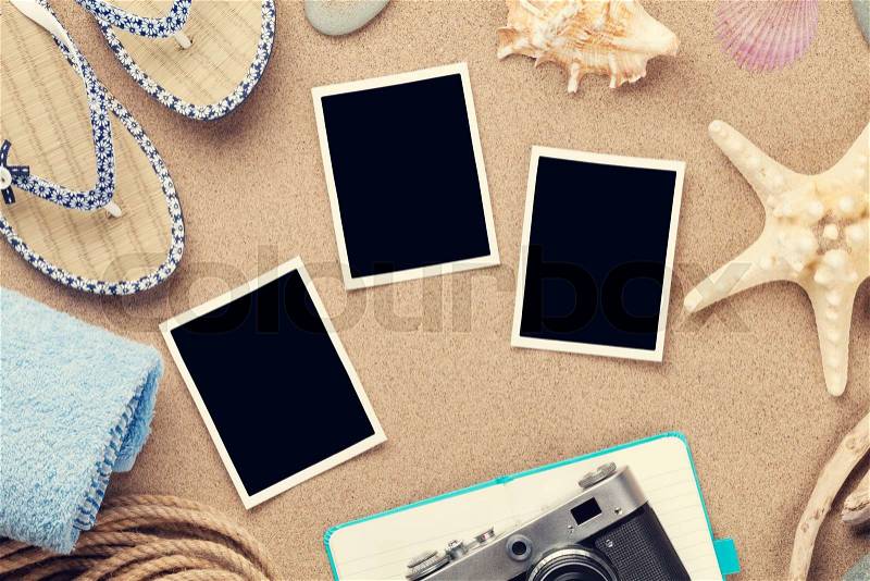 Travel and vacation photo frames and items over sea sand. Top view. Toned, stock photo