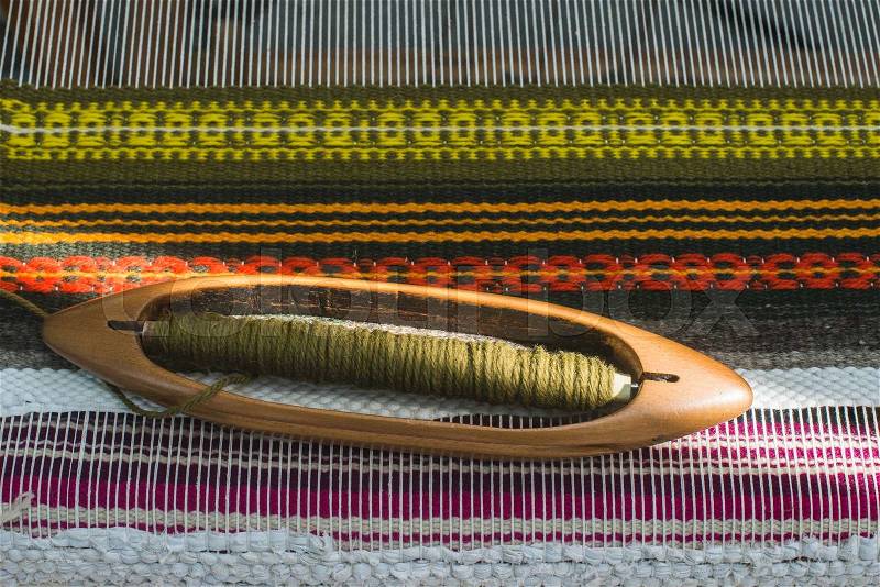 Vintage loom and yarn. Knitting carpet, stock photo