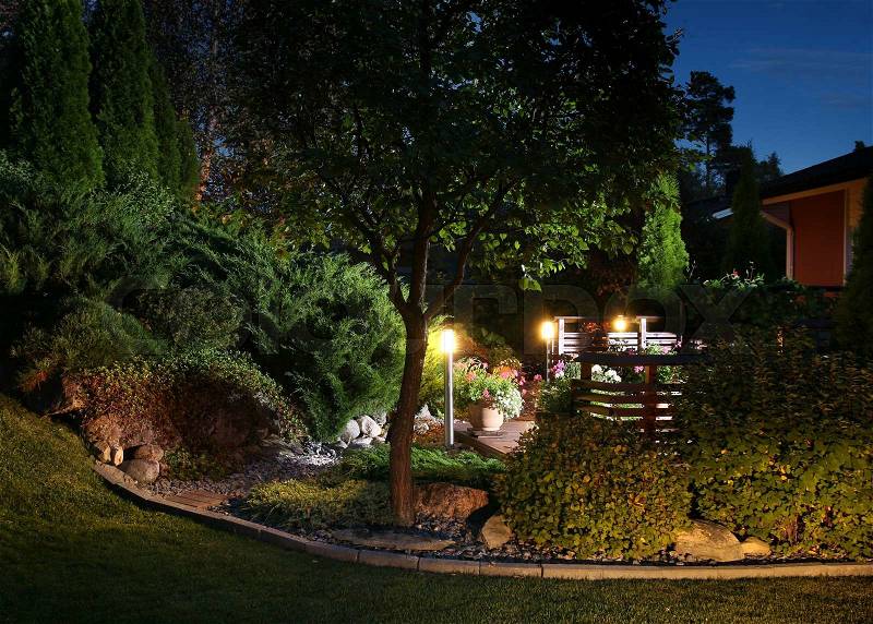 Illuminated home garden evening patio lights illumination, stock photo
