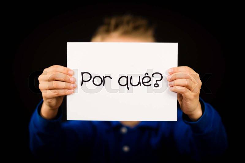 Studio shot of child holding a sign with Portuguese word Por Que - Why, stock photo