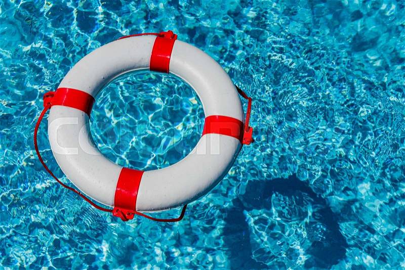 An emergency tire floating in a pool. symbolic photo for rescue and crisis management in the financial crisis and banking crisis, stock photo