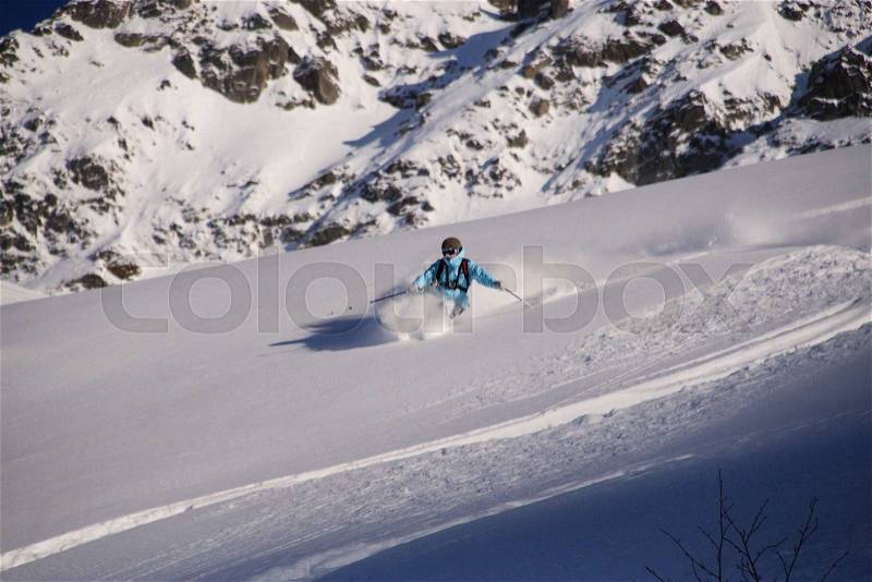 Skiing in powder with a sheaf of snow, stock photo