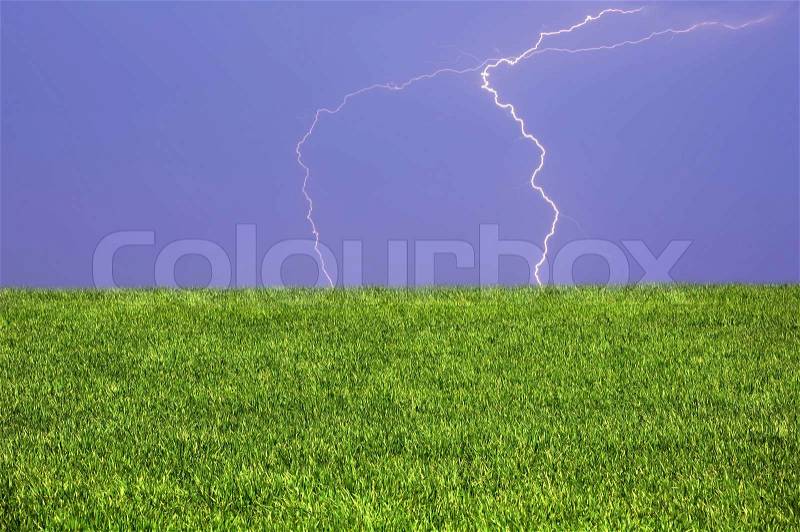 Perfect thunder-storm over field of grass, stock photo