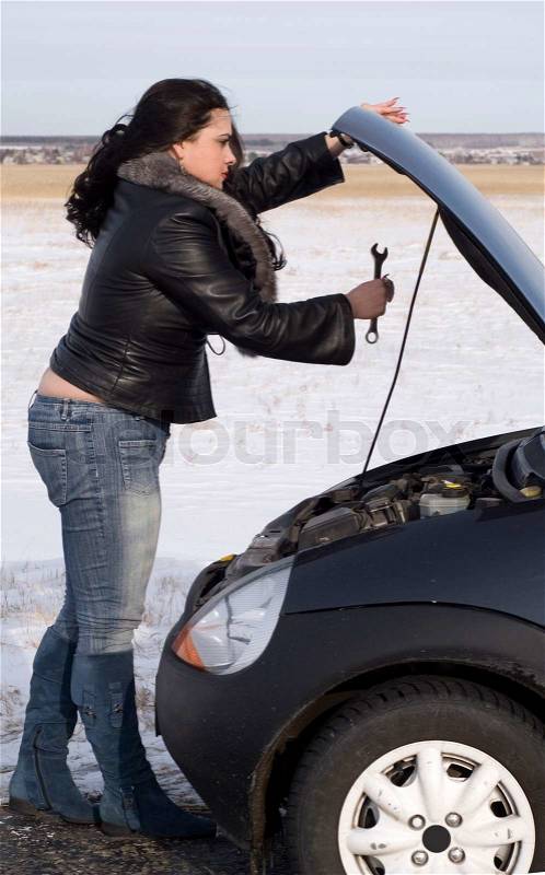 Woman with her broken car, stock photo