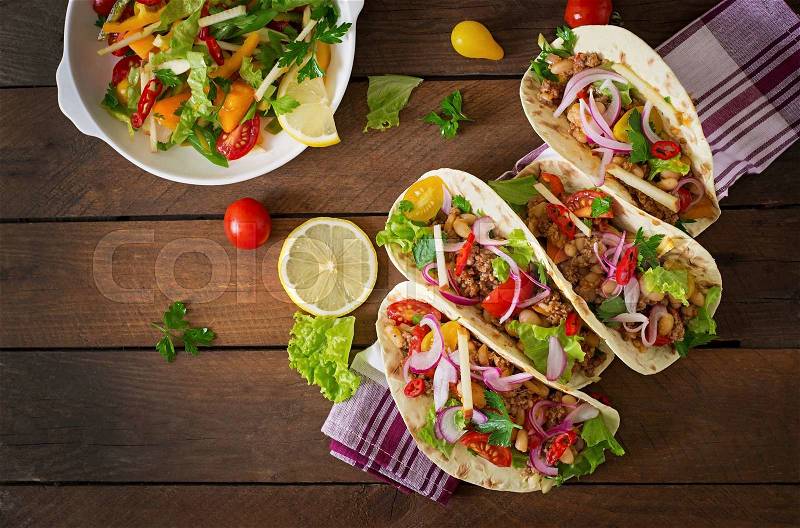 Mexican tacos with meat, beans and salsa. Top view, stock photo