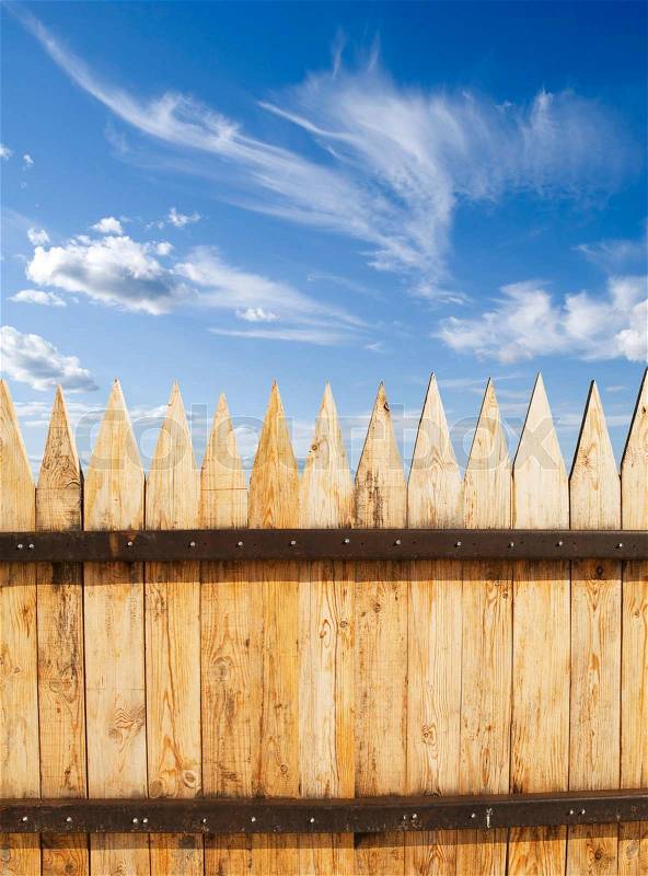 Wooded fence and blue sky, stock photo