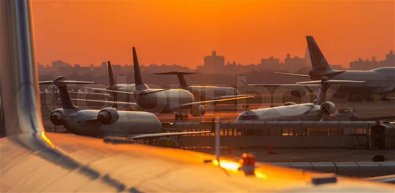 Sunset at the airport with airplanes ready to take off, stock photo