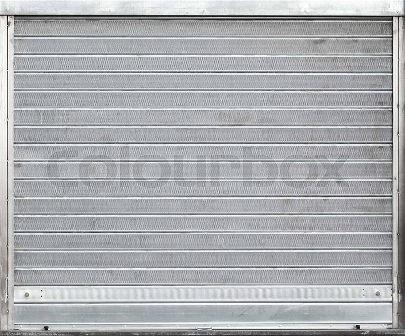 Gray metal garage gate with rolling shutters, background texture, stock photo