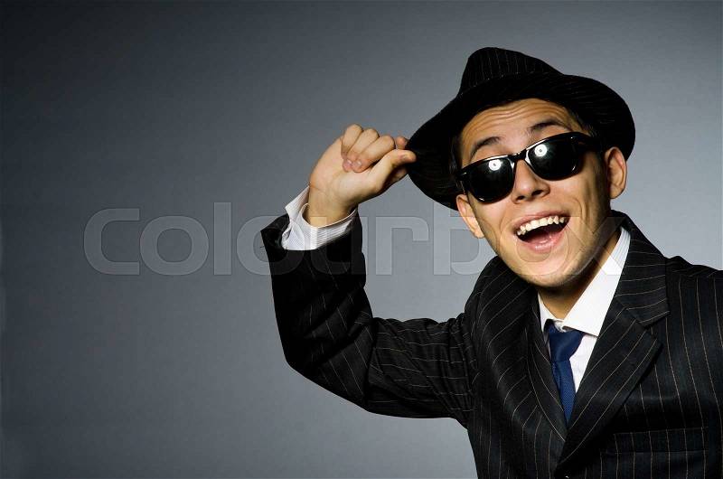 Young man in elegant suit against gray, stock photo