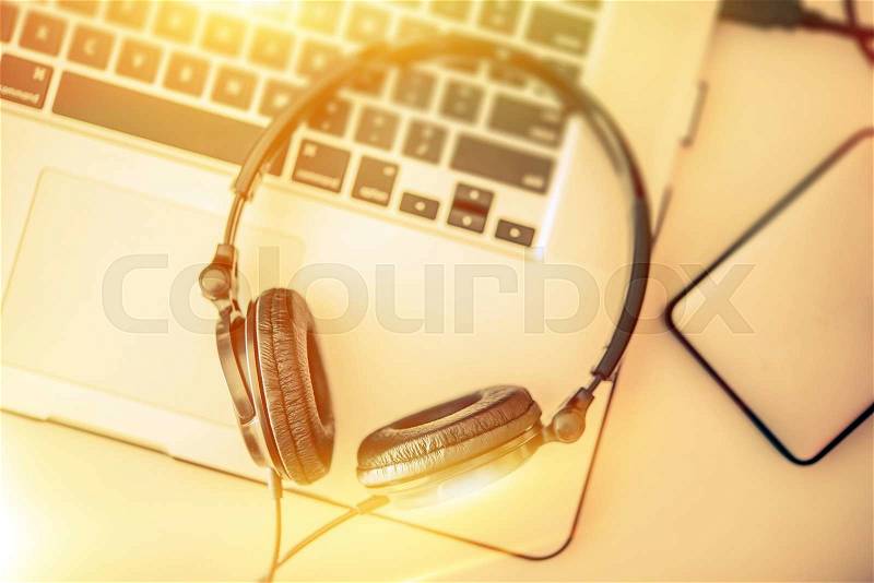 Online Music Listening. Headphones on the Laptop Computer and External Drive for Music Storage, stock photo