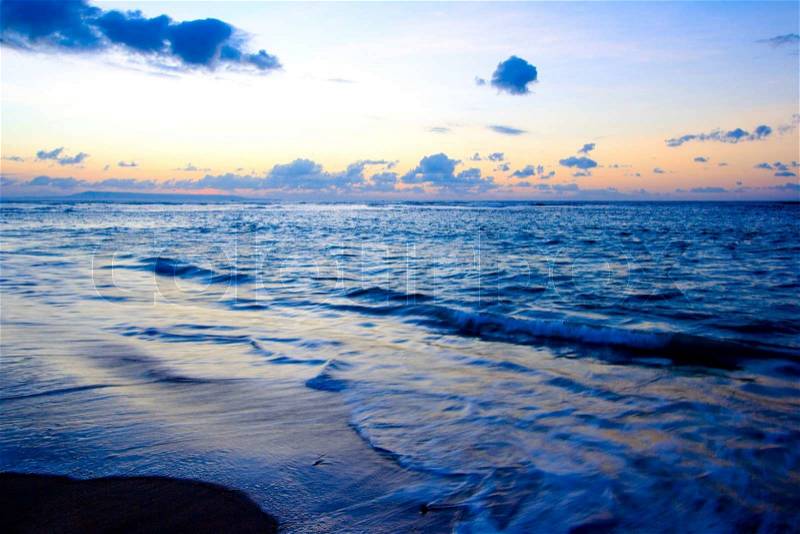 Calm peaceful ocean and beach on tropical sunrise, stock photo