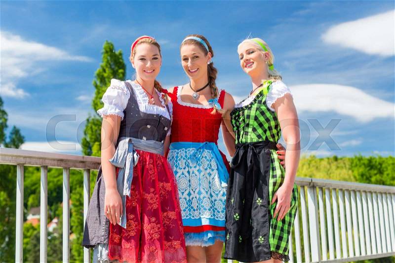Friends visiting together Bavarian fair in national costume or Dirndl , stock photo